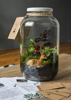 A beautiful glass jar terrarium with miniature plants and a deer figurine creates a serene indoor garden scene.